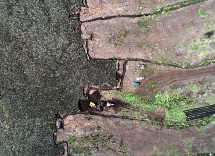 An aerial image of a peatland, with the right half appearing dryer than the left.