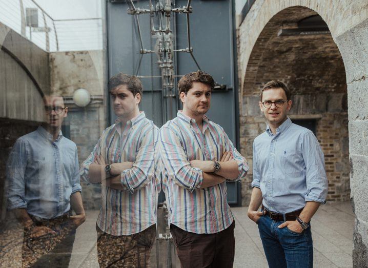 Headshot of the two founders of Oblivious. They are standing next to a glass wall on which their reflections can be seen.