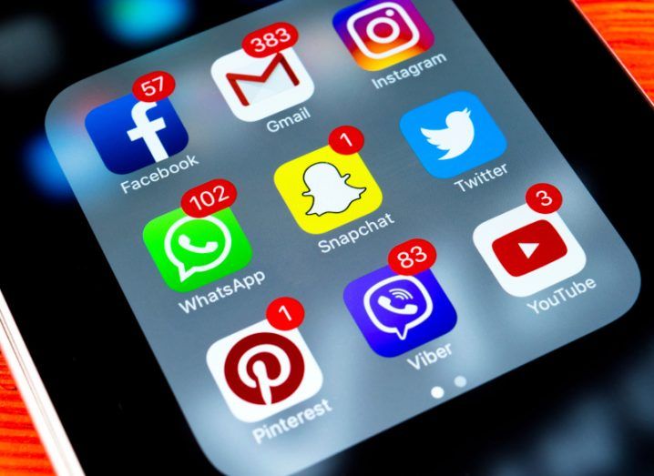 An image of a phone screen showing icons for various social media apps, some of which have notifications pending.