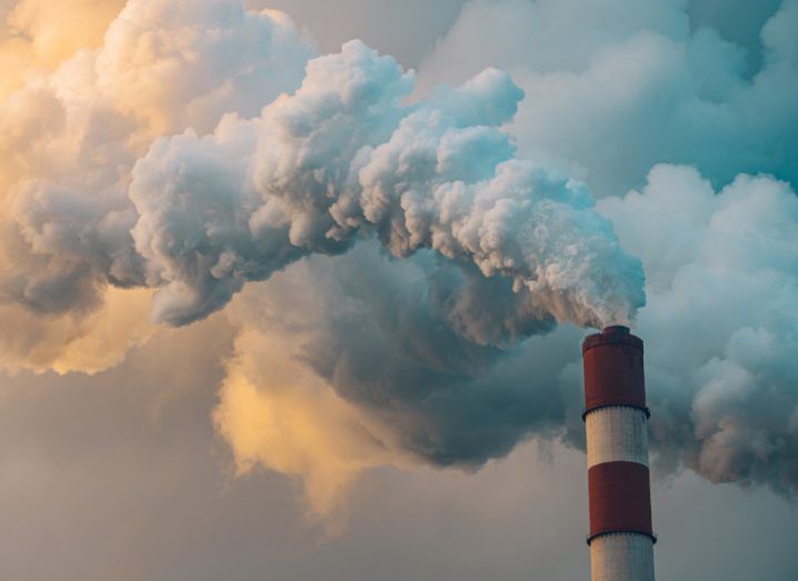 A plume of smoke rising from a factory chimney.