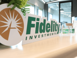 A woman with blonde hair smiles at the camera wearing a blue blouse. She is Kate Feeney, a senior manager at Fidelity Investments.
